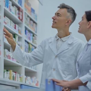 two druggists in lab coats in the process of inventory in a drugstore